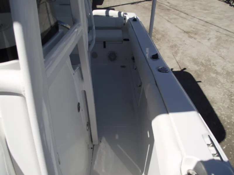 Slide: The Image of 2017 Sea Hunt Ultra 211 boat interior, showcasing side deck and seating area. - 13