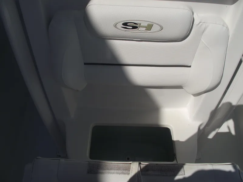 Slide: The Image of 2017 Sea Hunt Ultra 211 boat interior with cushioned seating and storage compartment. - 15