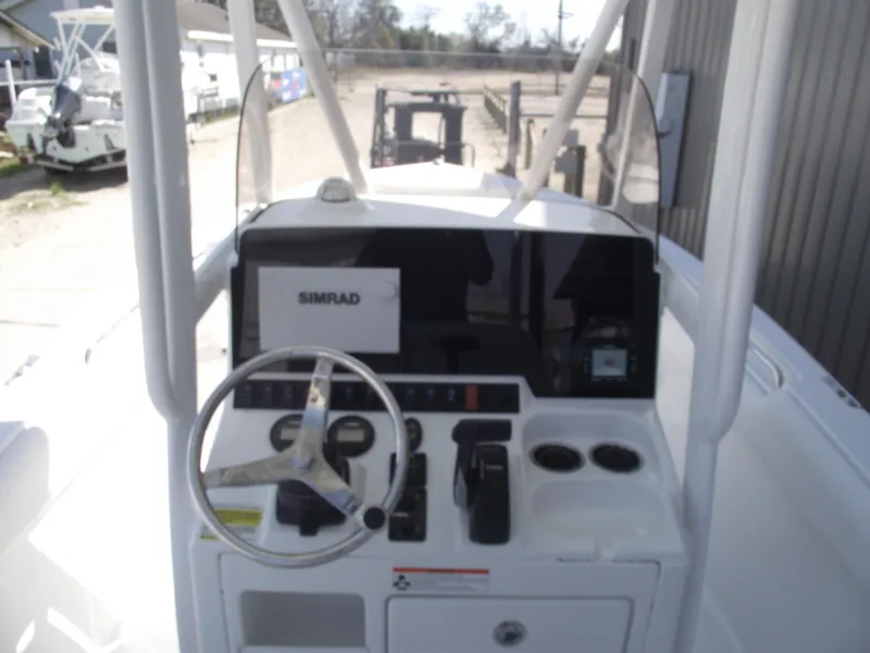 Slide: The Image of 2017 Sea Hunt Ultra 211 boat console with steering wheel and Simrad display. - 17