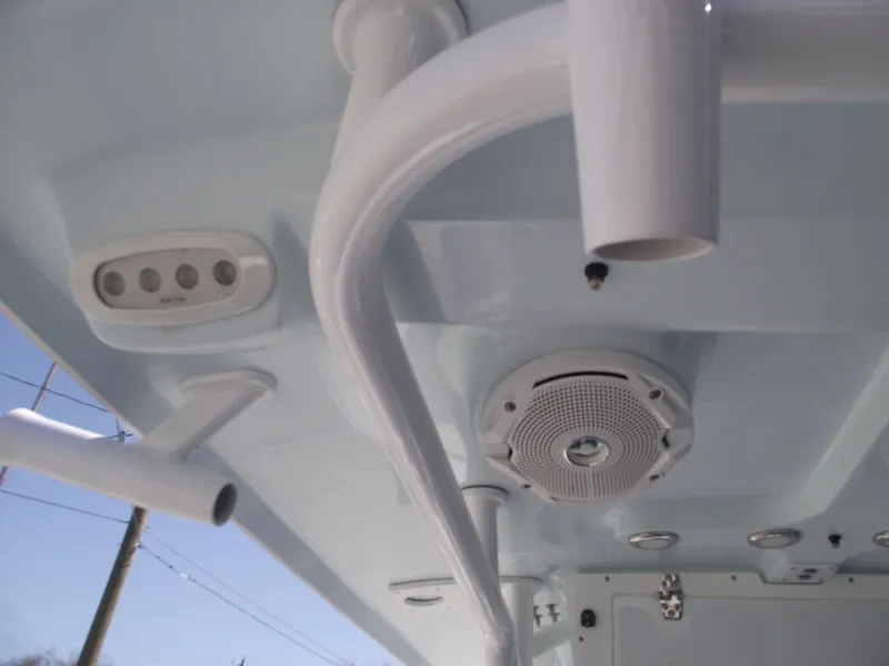 Slide: The Image of 2017 Sea Hunt Ultra 211 boat interior with speaker and rod holders. - 19