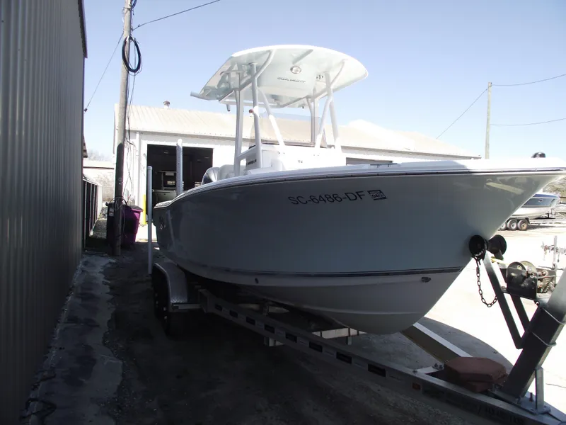 Slide: The Image of 2017 Sea Hunt Ultra 211 boat on trailer near a building. - 2