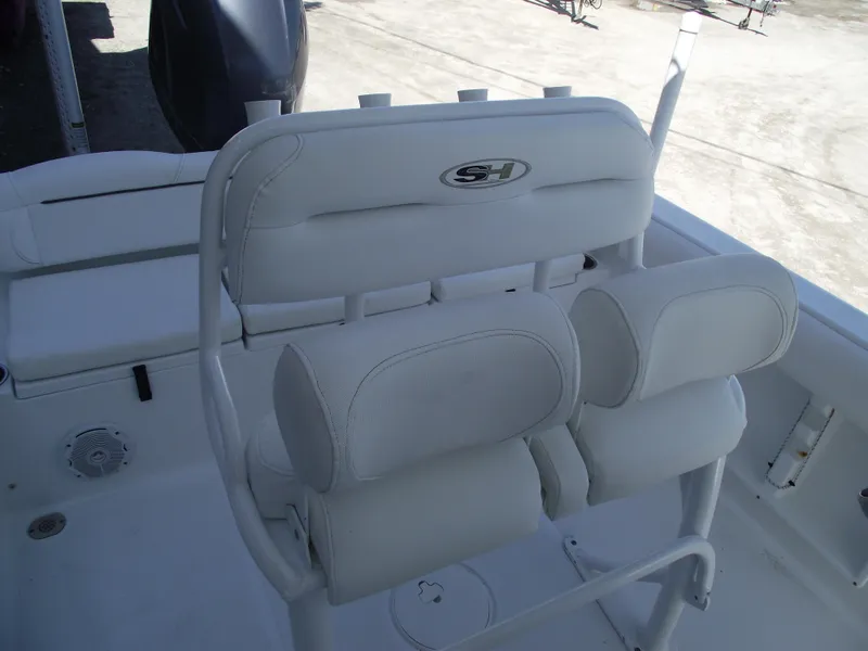 Slide: The Image of 2017 Sea Hunt Ultra 211 boat seating with white cushioned seats and backrest. - 20
