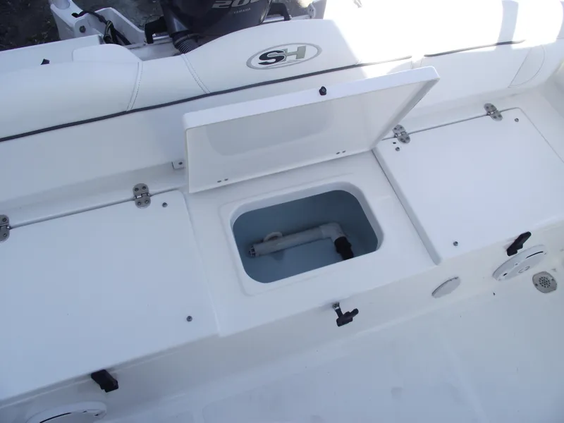 Slide: The Image of 2017 Sea Hunt Ultra 211 boat storage compartments with open hatch. - 27