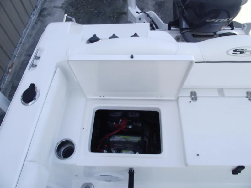 Slide: The Image of 2017 Sea Hunt Ultra 211 boat battery compartment with open hatch. - 28