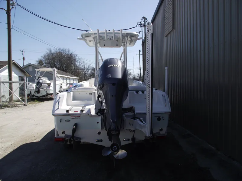 Slide: The Image of 2017 Sea Hunt Ultra 211 boat with outboard motor, parked outdoors. - 3