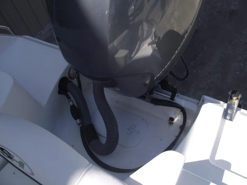 Slide: The Image of 2017 Sea Hunt Ultra 211 boat engine area with visible hoses and fittings. - 30