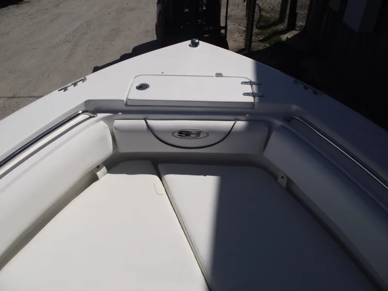 Slide: The Image of 2017 Sea Hunt Ultra 211 boat interior, featuring cushioned seating and storage compartment. - 5