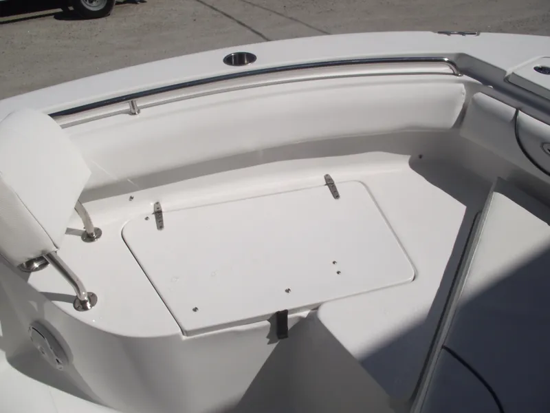 Slide: The Image of 2017 Sea Hunt Ultra 211 boat interior with white seating and storage compartment. - 7