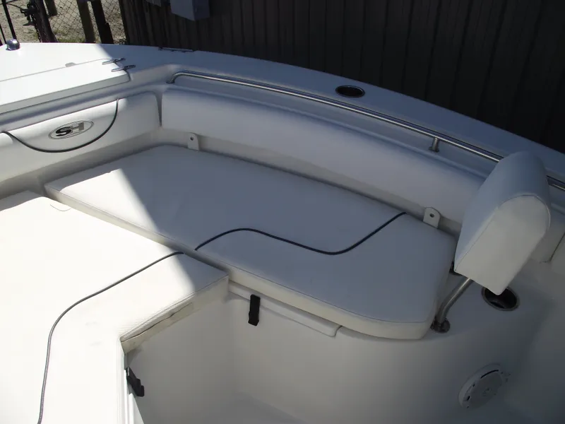 Slide: The Image of 2017 Sea Hunt Ultra 211 boat interior seating area with white cushions. - 9