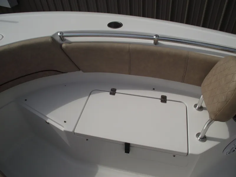 Slide: The Image of 2019 Sportsman Open 232 Center Console boat interior with cushioned seating and storage. - 11