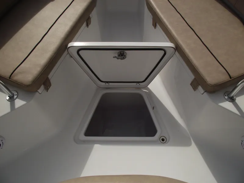 Slide: The Image of 2019 Sportsman Open 232 Center Console boat storage compartment with open hatch. - 16