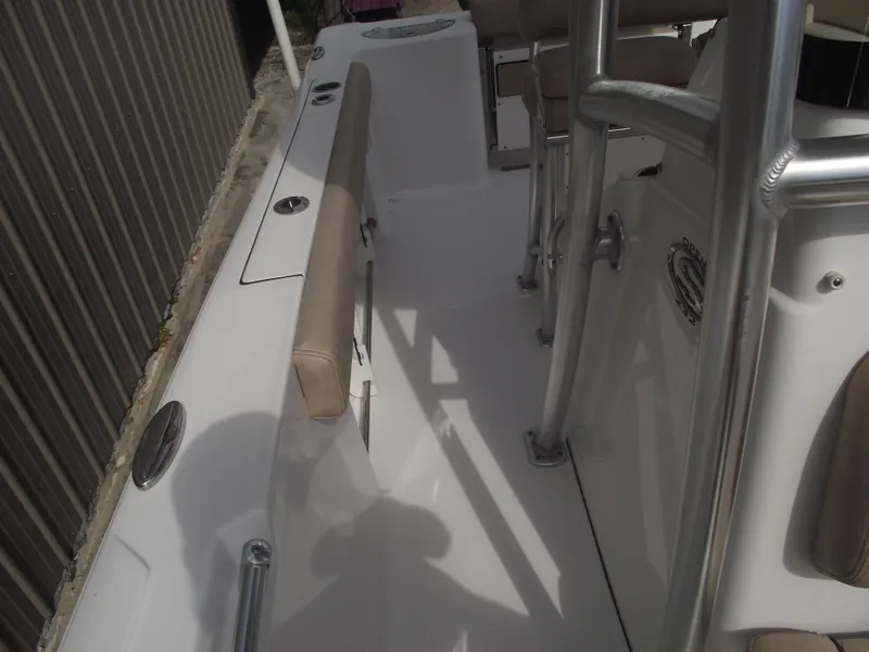Slide: The Image of 2019 Sportsman Open 232 Center Console boat interior with seating and console view. - 19