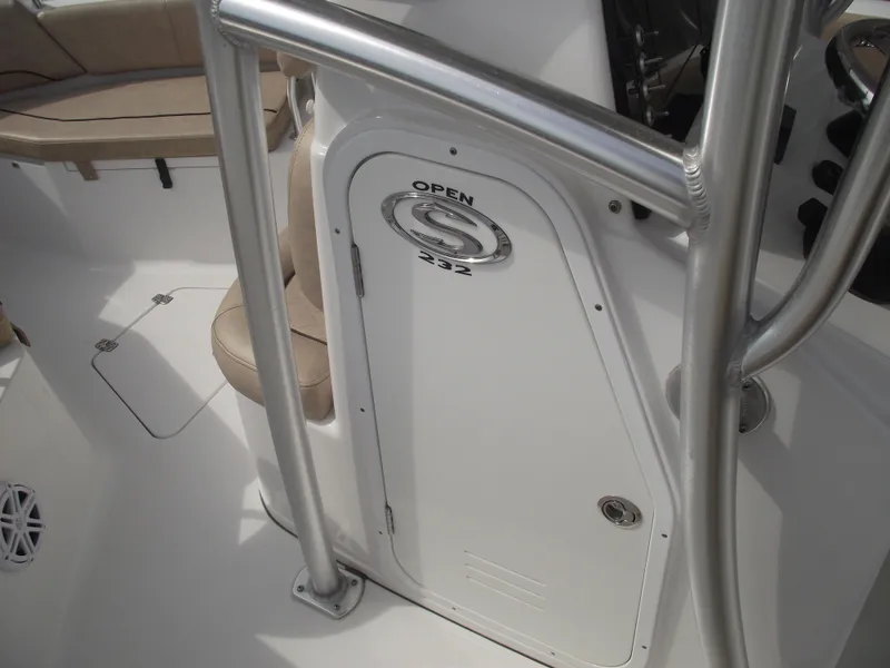 Slide: The Image of 2019 Sportsman Open 232 Center Console boat interior with seating and storage compartment. - 20