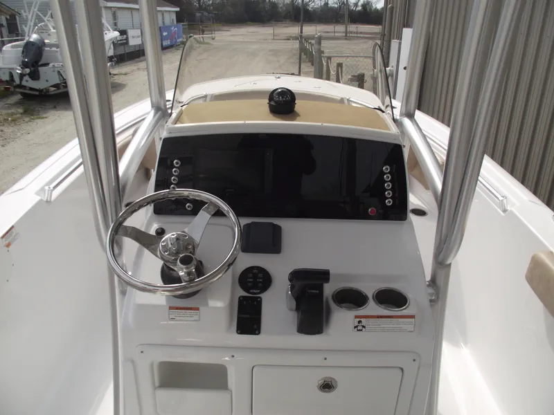 Slide: The Image of 2019 Sportsman Open 232 Center Console boat dashboard with steering wheel and controls. - 22