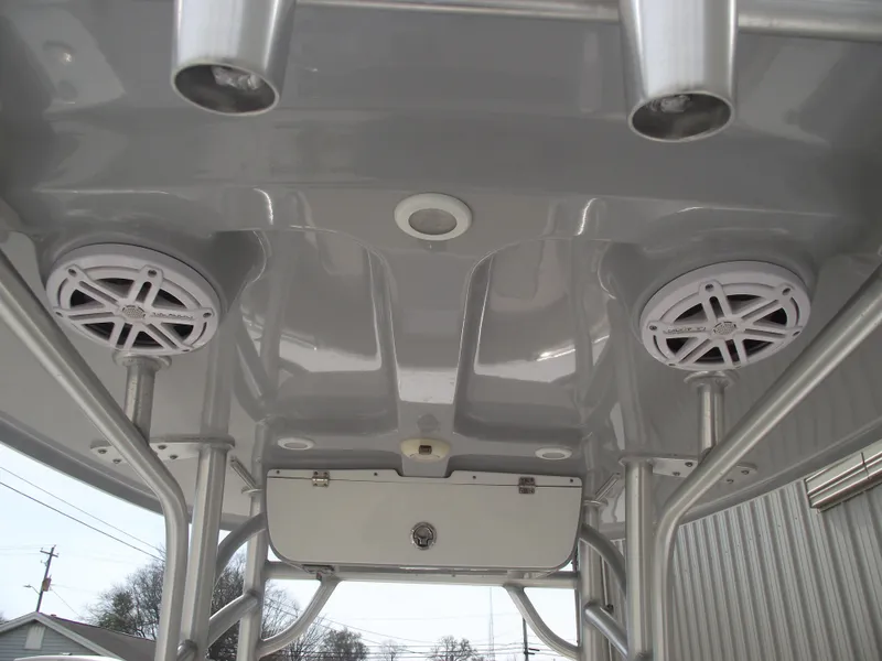 Slide: The Image of 2019 Sportsman Open 232 Center Console boat with speakers and rod holders. - 23