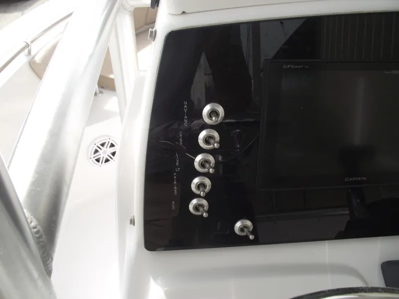 Slide: The Image of 2019 Sportsman Open 232 Center Console dashboard with control panel and display screen. - 24