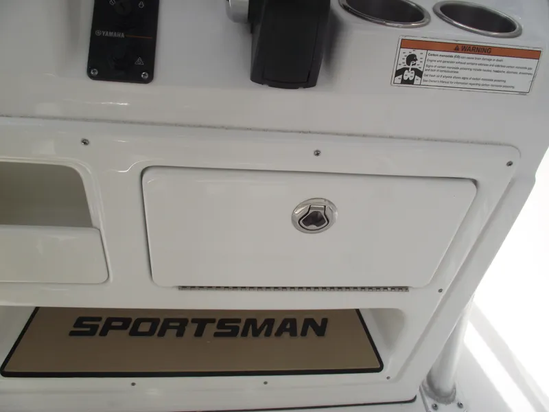 Slide: The Image of 2019 Sportsman Open 232 Center Console dashboard with storage compartment and cup holders. - 25