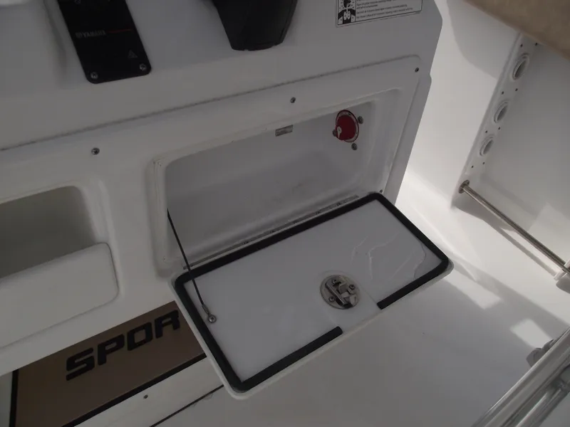 Slide: The Image of 2019 Sportsman Open 232 Center Console storage compartment with open hatch. - 26
