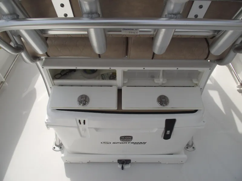 Slide: The Image of 2019 Sportsman Open 232 Center Console boat storage compartments and cooler. - 29