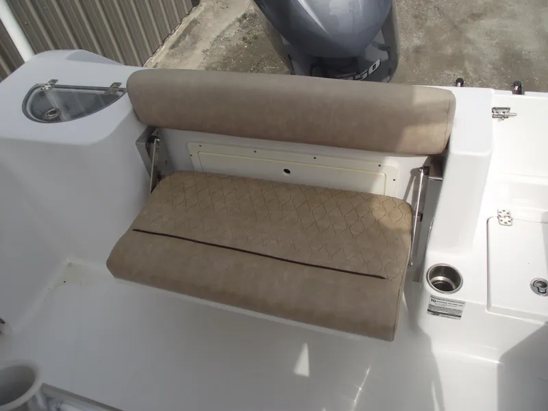 Slide: The Image of 2019 Sportsman Open 232 Center Console boat with beige cushioned seating. - 31
