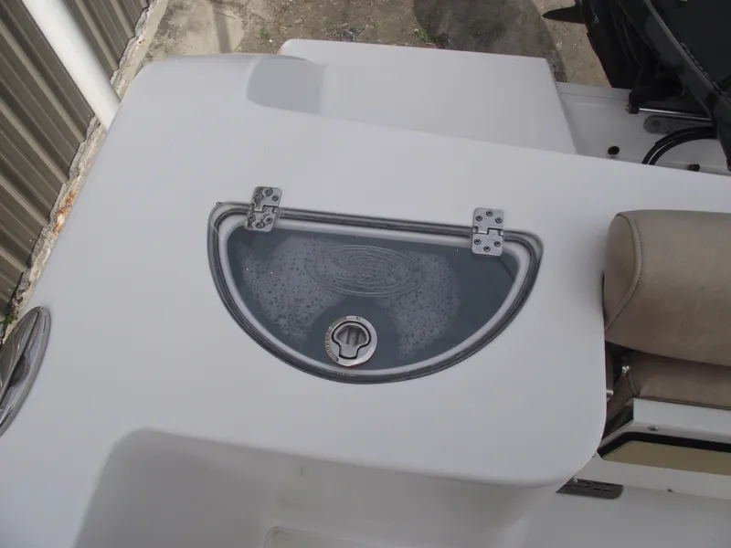 Slide: The Image of 2019 Sportsman Open 232 Center Console boat with a closed storage compartment. - 32