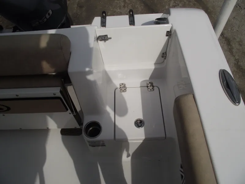 Slide: The Image of 2019 Sportsman Open 232 Center Console boat interior with seating and storage. - 34