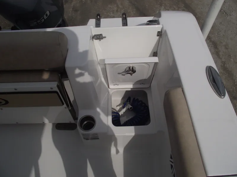 Slide: The Image of 2019 Sportsman Open 232 Center Console boat interior with storage compartment and seating. - 35