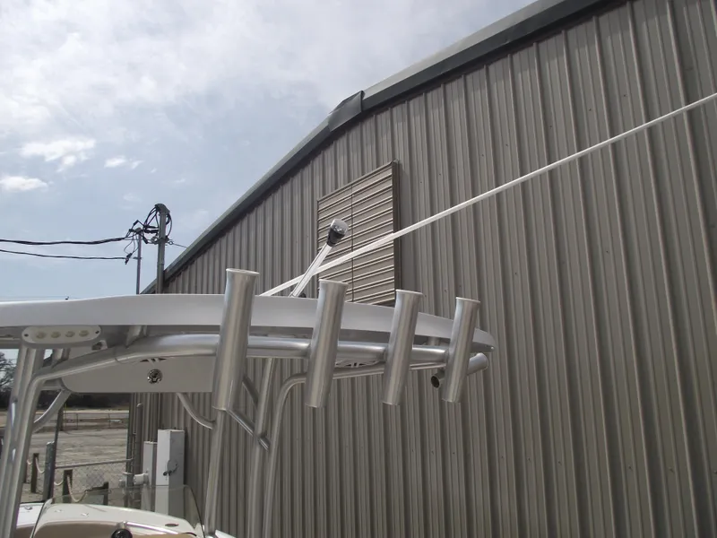 Slide: The Image of 2019 Sportsman Open 232 Center Console boat near a metal building. - 37
