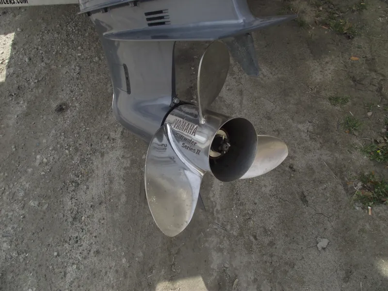 Slide: The Image of Propeller of 2019 Sportsman Open 232 Center Console boat on sandy ground. - 4