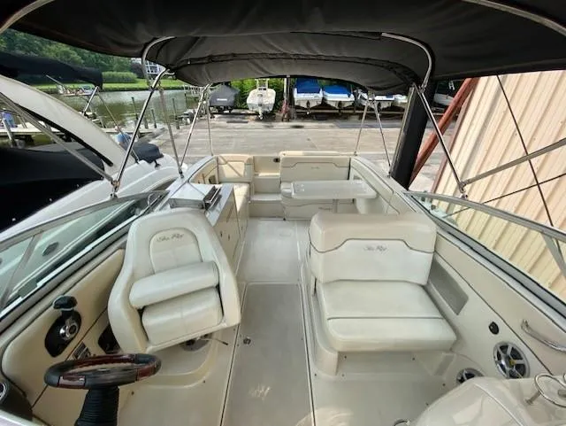 Slide: The Image of 2008 Sea Ray 290 Sundeck boat interior with seating and steering wheel. - 13