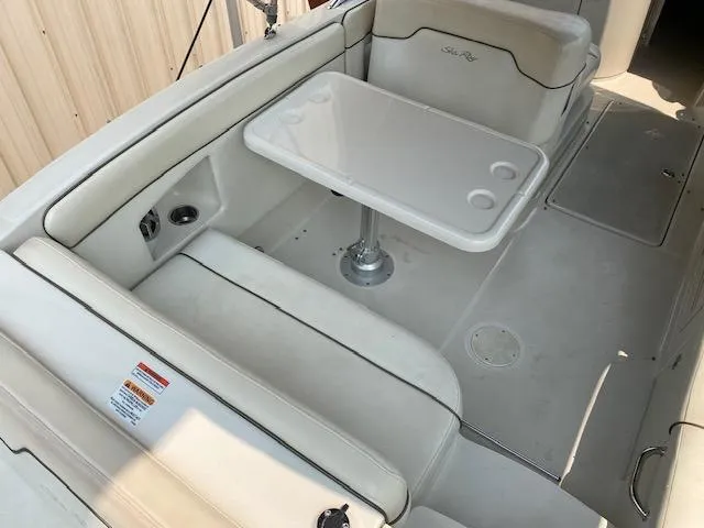 Slide: The Image of 2008 Sea Ray 290 Sundeck interior with white seating and table. - 16