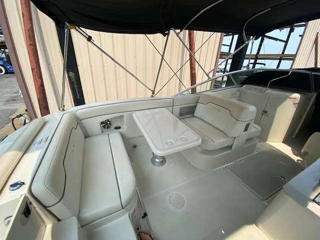 Slide: The Image of 2008 Sea Ray 290 Sundeck interior with seating and table under canopy. - 17