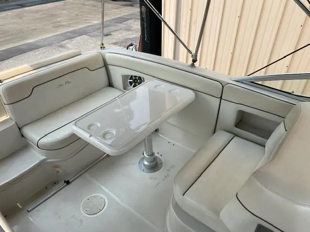 Slide: The Image of 2008 Sea Ray 290 Sundeck interior with seating and table, showcasing luxury boat design. - 18