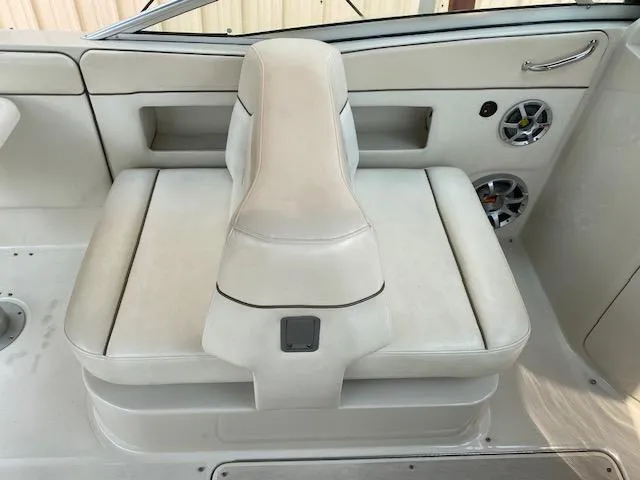Slide: The Image of 2008 Sea Ray 290 Sundeck boat interior with white seating and built-in speakers. - 20