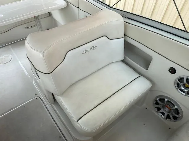 Slide: The Image of 2008 Sea Ray 290 Sundeck boat interior with white seating and speaker system. - 21