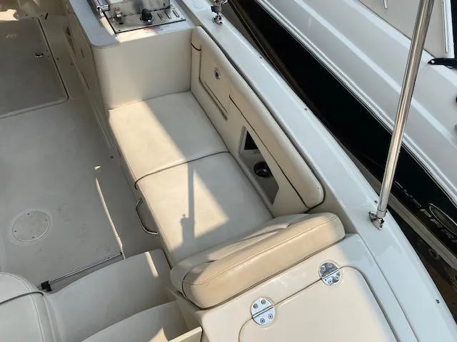 Slide: The Image of 2008 Sea Ray 290 Sundeck interior with beige seating and storage compartments. - 26