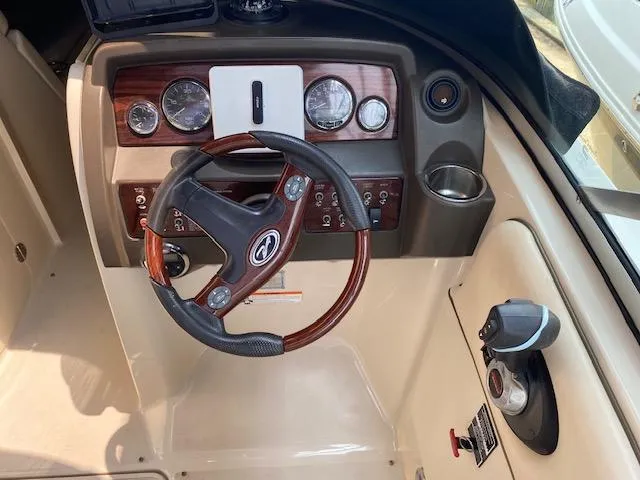 Slide: The Image of 2008 Sea Ray 290 Sundeck dashboard with wood accents and steering wheel. - 29