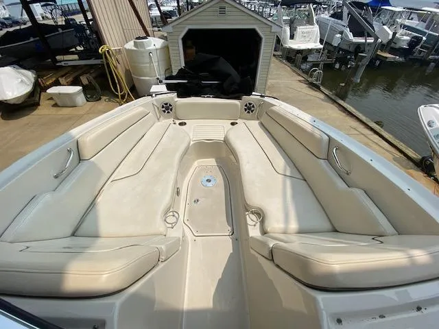 Slide: The Image of 2008 Sea Ray 290 Sundeck boat interior with spacious seating at a marina. - 32