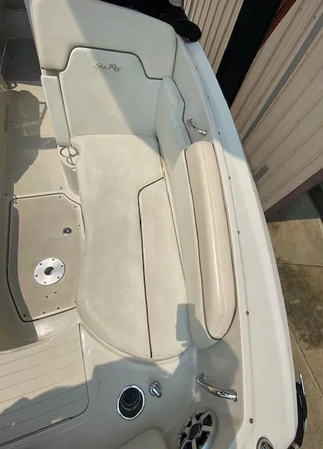 Slide: The Image of 2008 Sea Ray 290 Sundeck boat interior with beige seating and deck details. - 35