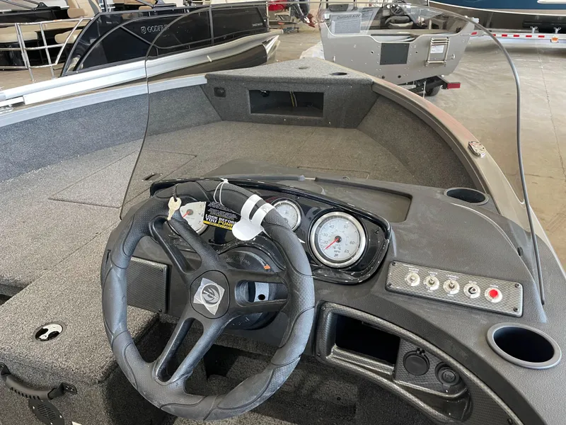 Slide: The Image of 2025 Crestliner 1750 Hawk boat interior with steering wheel and dashboard controls. - 15