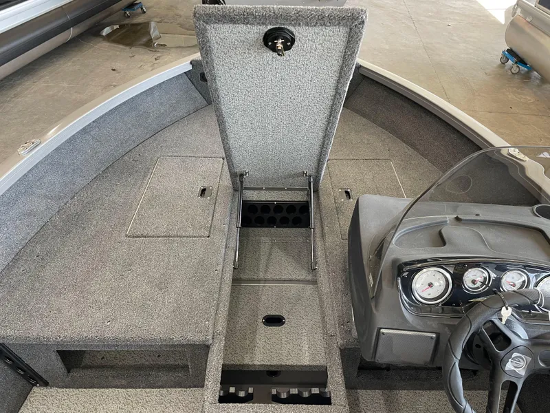 Slide: The Image of 2025 Crestliner 1750 Hawk boat interior with storage compartments and dashboard. - 16