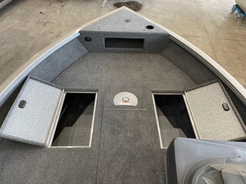 Slide: The Image of 2025 Crestliner 1750 Hawk boat interior with open storage compartments. - 17