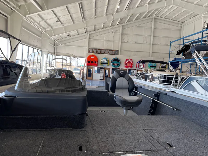 Slide: The Image of 2025 Crestliner 1750 Hawk boat interior in showroom with seating and dashboard. - 19