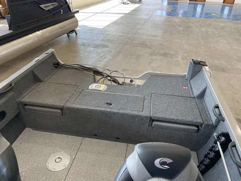 Slide: The Image of 2025 Crestliner 1750 Hawk boat interior with gray seating and storage compartments. - 4