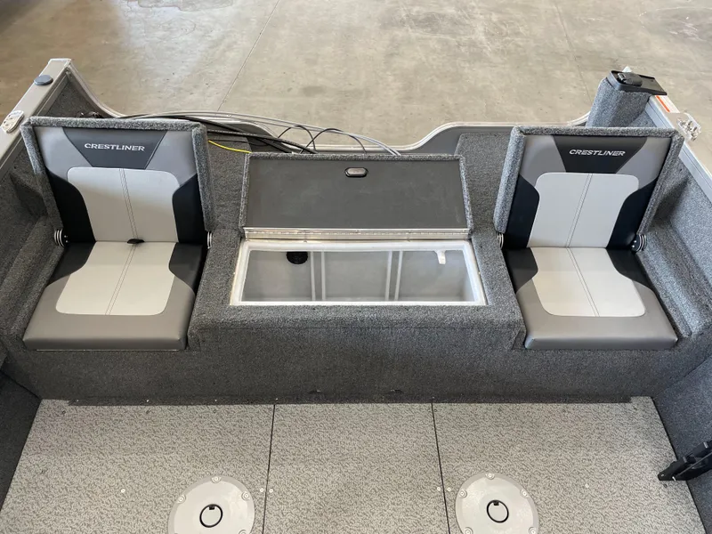 Slide: The Image of 2025 Crestliner 1750 Hawk boat interior with dual seats and storage compartment. - 5