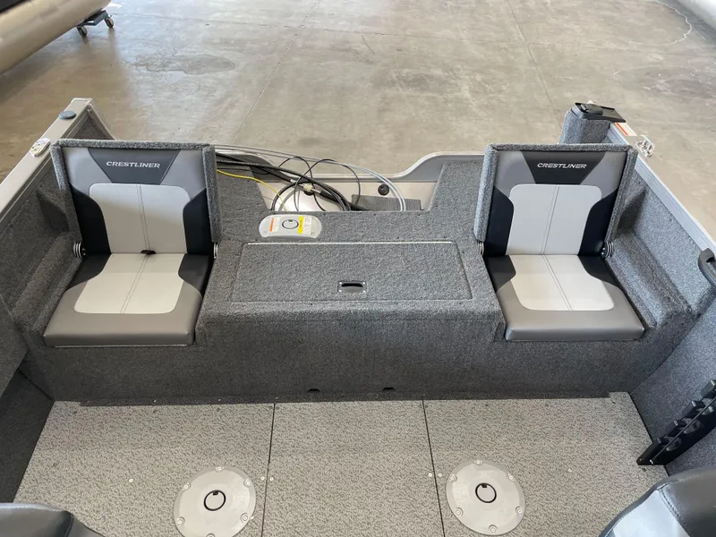 Slide: The Image of 2025 Crestliner 1750 Hawk boat interior with dual seats and storage compartment. - 6