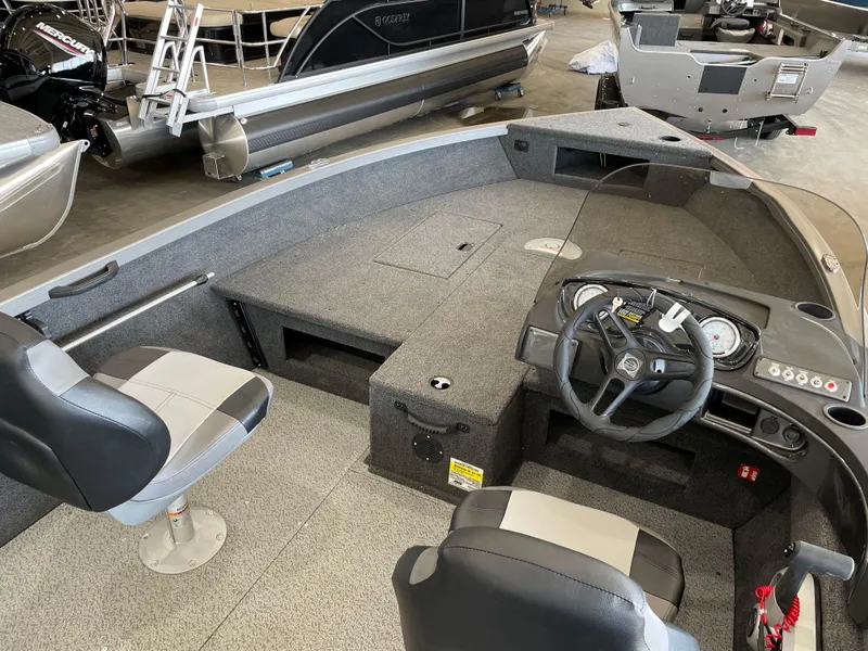 Slide: The Image of 2025 Crestliner 1750 Hawk boat interior with steering wheel and seating. - 7