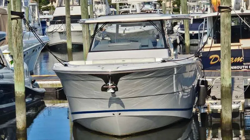 Slide: The Image of 2021 Regal 38 SAV boat docked in a marina, front view. - 1