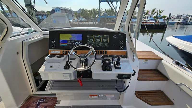 Slide: The Image of 2021 Regal 38 SAV boat helm with modern controls and navigation displays. - 13