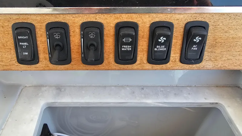Slide: The Image of Control panel of 2021 Regal 38 SAV boat with various switches. - 20